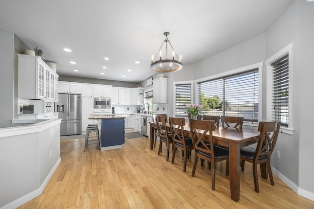 92104 E Sagebrush Rd, Kennewick, WA 99338 - dining room with a chandelier, light wood-style floors, baseboards, and recessed lighting
