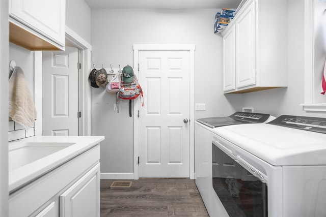 92104 E Sagebrush Rd, Kennewick, WA 99338 - laundry room featuring washer and dryer, cabinet space, and dark wood-style flooring