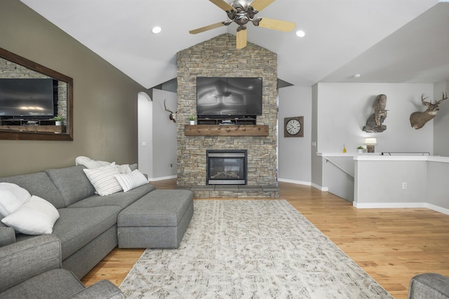92104 E Sagebrush Rd, Kennewick, WA 99338 - living room featuring wood finished floors, ceiling fan, lofted ceiling, baseboards, and a stone fireplace