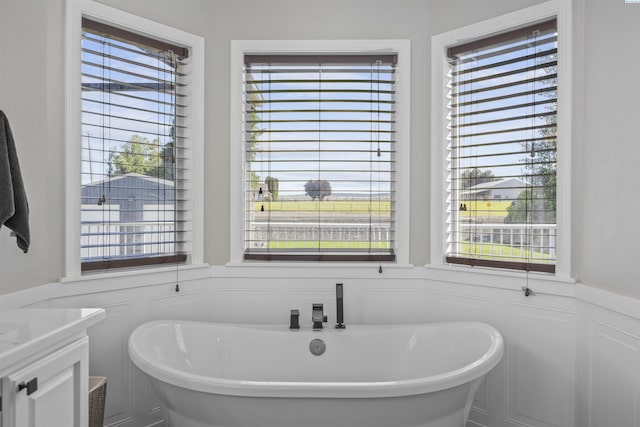 92104 E Sagebrush Rd, Kennewick, WA 99338 - bathroom featuring a soaking tub, wainscoting, vanity, and a decorative wall
