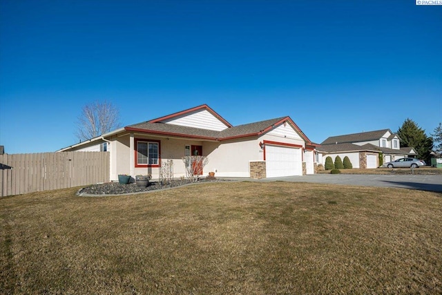 single story home featuring stucco siding, a front yard, fence, a garage, and driveway