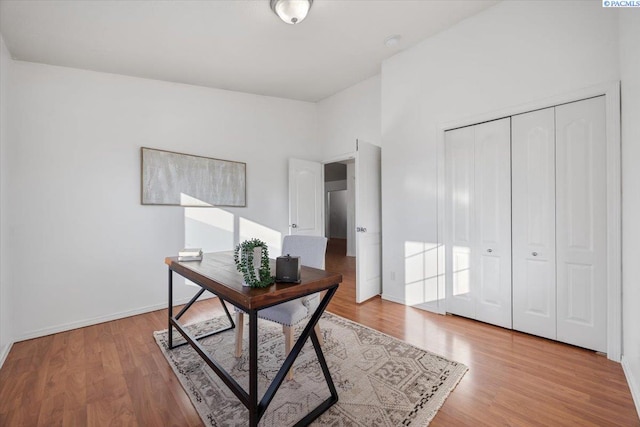 home office with wood finished floors and baseboards