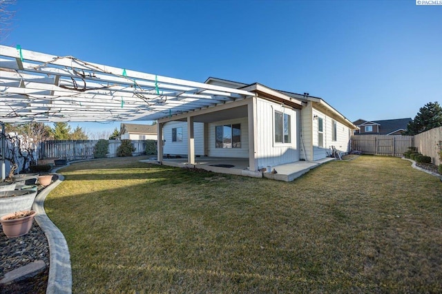 rear view of property with a yard, a patio, a fenced backyard, and board and batten siding