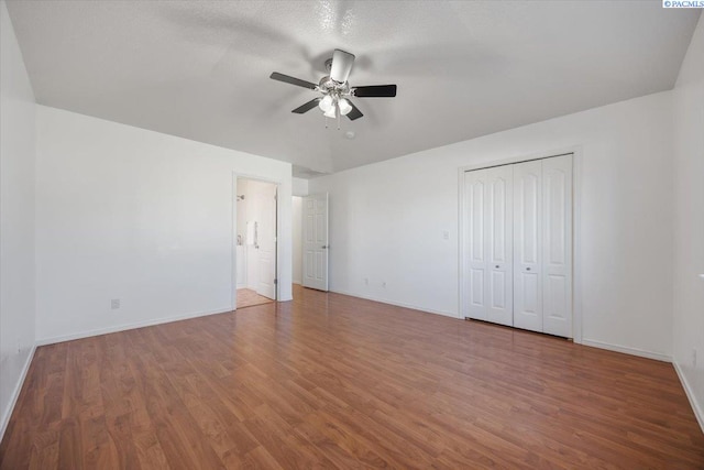 unfurnished bedroom with baseboards and wood finished floors