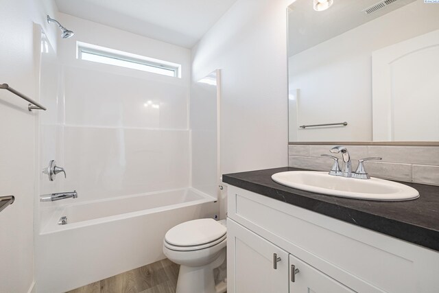 1613 Diamond Ave, Grandview, WA 98930 - bathroom with vanity, toilet, shower / bath combination, and wood finished floors