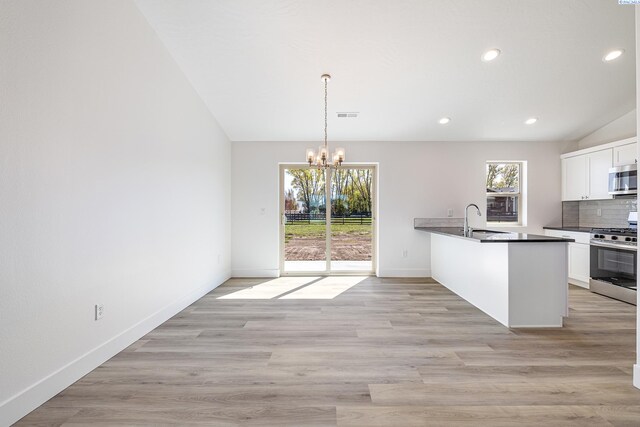 1613 Diamond Ave, Grandview, WA 98930 - kitchen with stainless steel appliances, a sink, a chandelier, a peninsula, and healthy amount of natural light