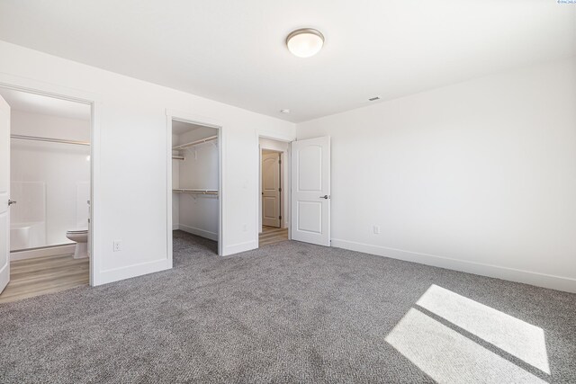 1613 Diamond Ave, Grandview, WA 98930 - unfurnished bedroom with carpet, baseboards, a walk in closet, and a closet