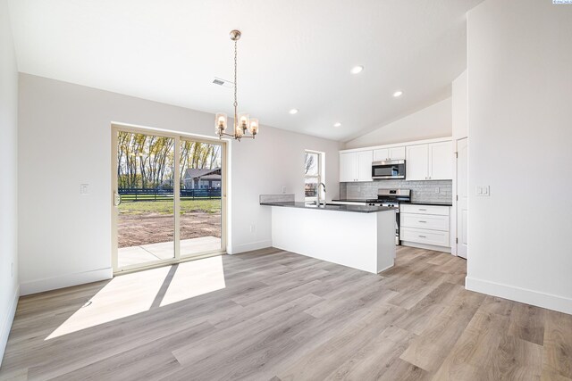 1613 Diamond Ave, Grandview, WA 98930 - kitchen with stainless steel appliances, dark countertops, a sink, a chandelier, and healthy amount of natural light