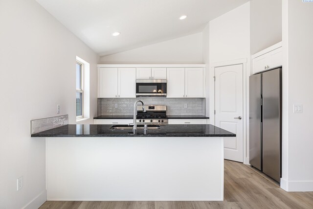 1613 Diamond Ave, Grandview, WA 98930 - kitchen featuring stainless steel appliances, a sink, dark stone countertops, white cabinets, and lofted ceiling