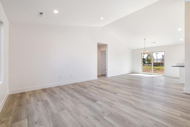 1613 Diamond Ave, Grandview, WA 98930 - unfurnished living room with a chandelier, lofted ceiling, light wood-style floors, baseboards, and recessed lighting
