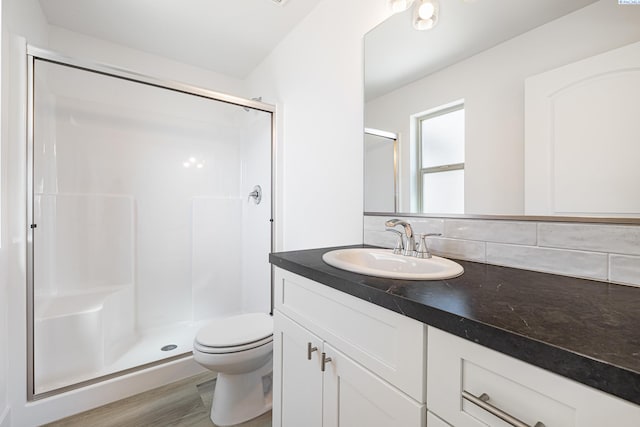 1613 Diamond Ave, Grandview, WA 98930 - bathroom featuring a stall shower, vanity, toilet, and wood finished floors