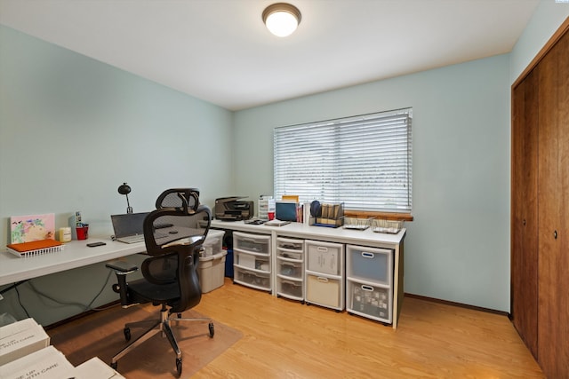 home office with light wood-style floors and baseboards