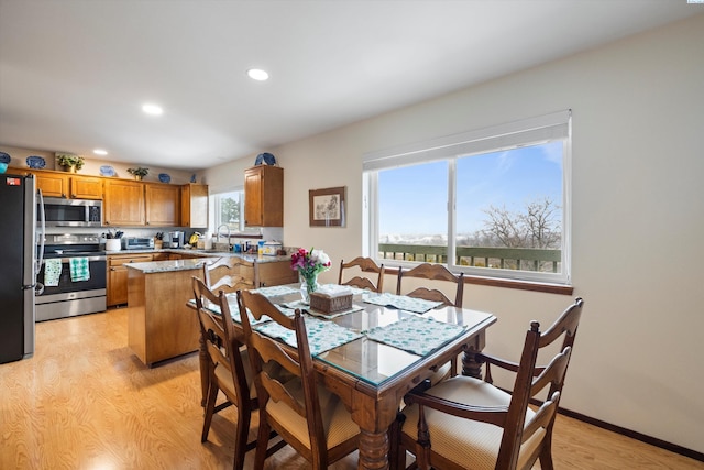 dining area with light wood-style floors, baseboards, and recessed lighting