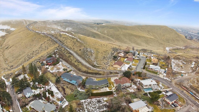 drone / aerial view featuring a residential view and a mountain view