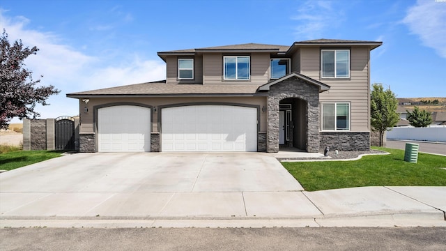 7104 W 31st Pl, Kennewick, WA 99338 - view of front of property featuring stone siding, driveway, an attached garage, and a gate