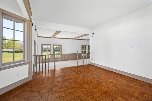 unfurnished room featuring dark parquet flooring and beamed ceiling