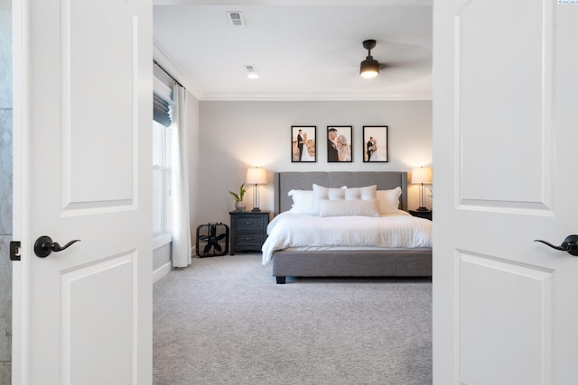 bedroom with ornamental molding, carpet, and visible vents