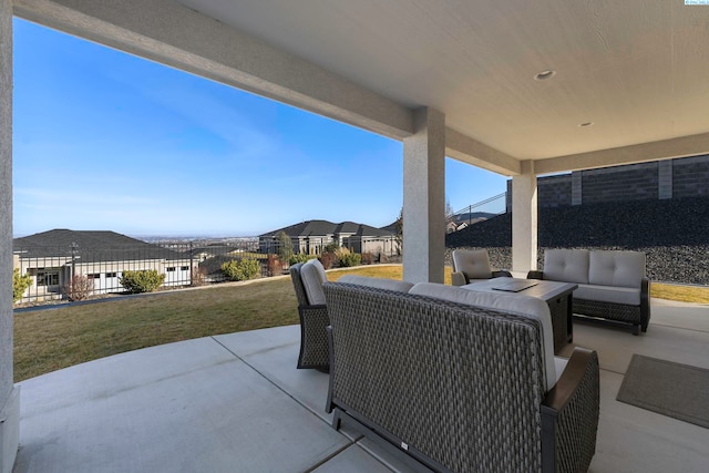 view of patio / terrace with outdoor lounge area, fence, and a residential view