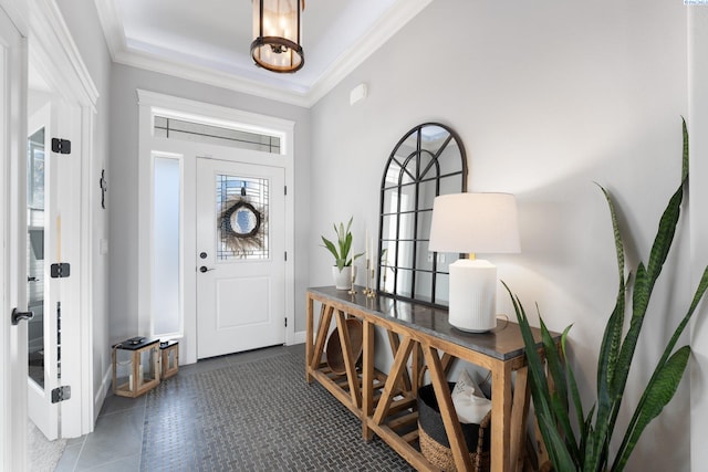 tiled entryway featuring crown molding