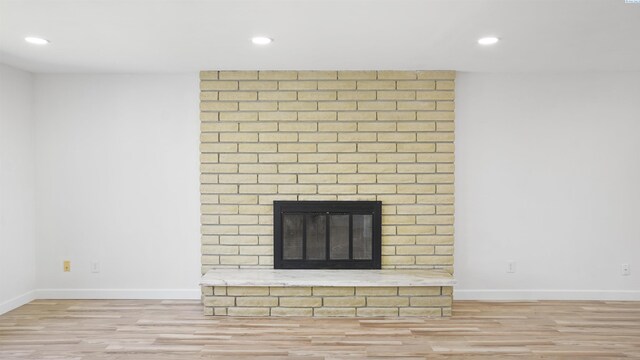 room details featuring hardwood / wood-style flooring and a brick fireplace