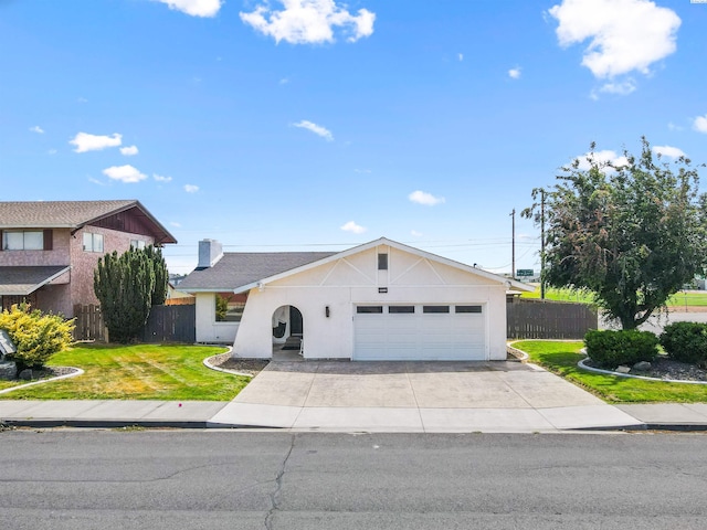 view of front of home with a garage and a front lawn