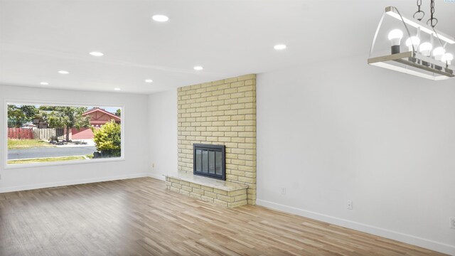 unfurnished living room with hardwood / wood-style flooring and a fireplace