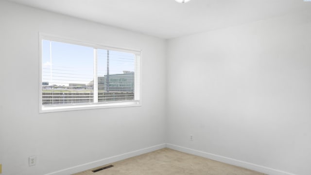 unfurnished room with light colored carpet