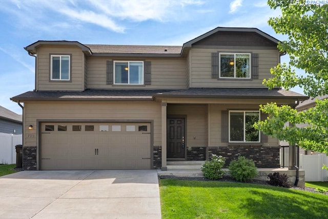 720 SW Wheat Ridge Dr, Pullman, WA 99163 - view of front facade featuring a garage, a front lawn, stone siding, and concrete driveway