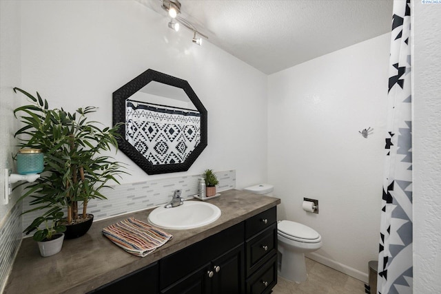 324 S Zinser St, Kennewick, WA 99336 - bathroom with vanity, decorative backsplash, and a textured ceiling