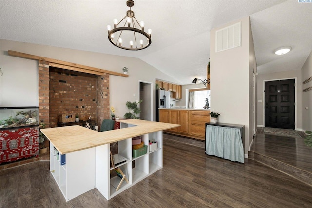 324 S Zinser St, Kennewick, WA 99336 - kitchen featuring lofted ceiling, a chandelier, dark wood-style flooring, stainless steel refrigerator with ice dispenser, and butcher block countertops