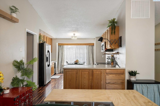 324 S Zinser St, Kennewick, WA 99336 - kitchen with stainless steel appliances, dark wood-style floors, light countertops, a textured ceiling, and brown cabinetry
