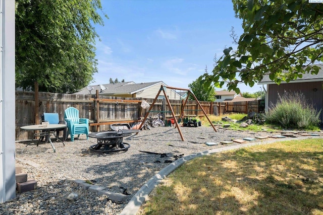 324 S Zinser St, Kennewick, WA 99336 - fenced backyard with a fire pit and a playground