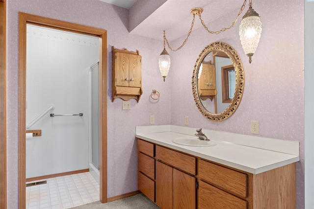 bathroom featuring vanity and a shower with shower door