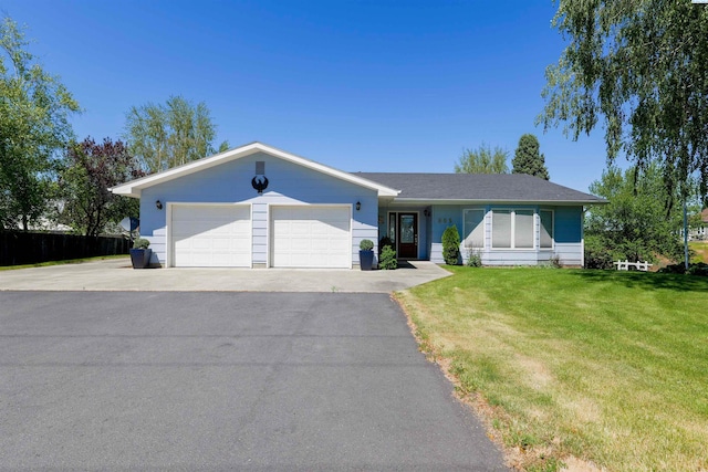 single story home with a garage and a front yard