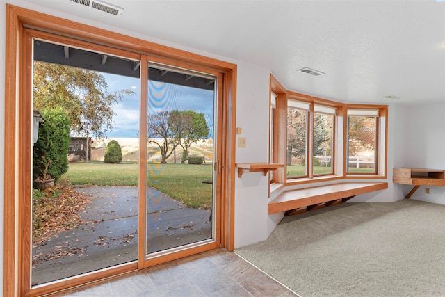 entryway featuring light colored carpet