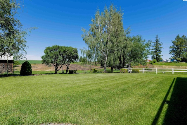 view of yard with a rural view