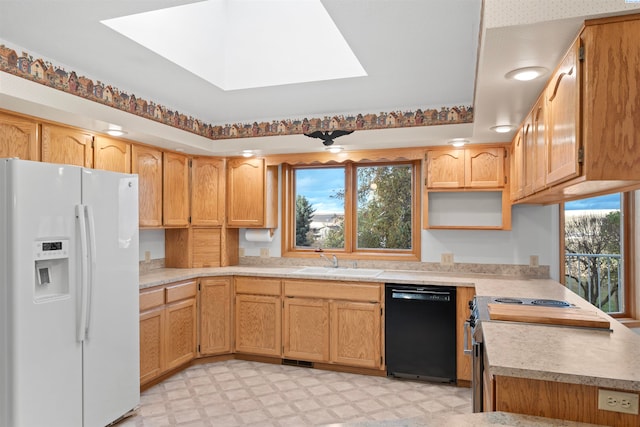 kitchen featuring electric stove, sink, dishwasher, a skylight, and white refrigerator with ice dispenser