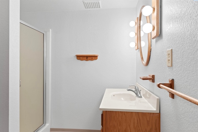 bathroom with vanity and walk in shower