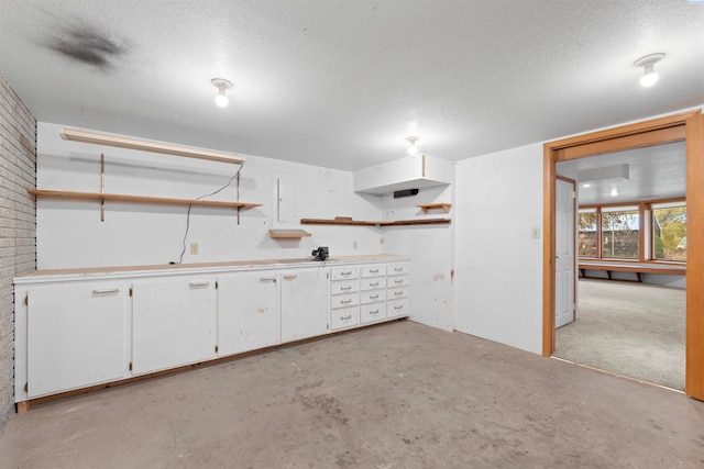 basement featuring a textured ceiling