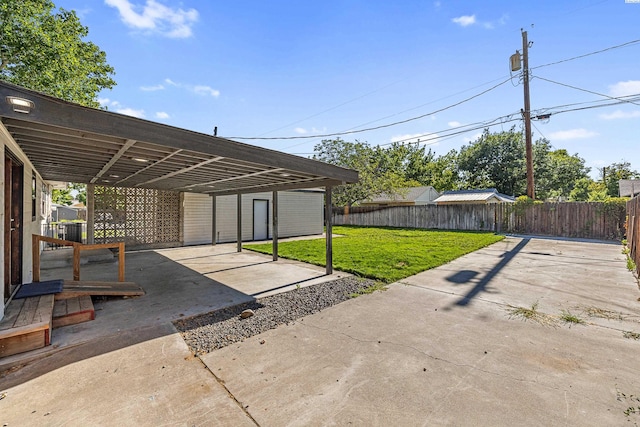 1301 Wright Ave, Richland, WA 99354 - fenced backyard featuring a patio and a detached carport