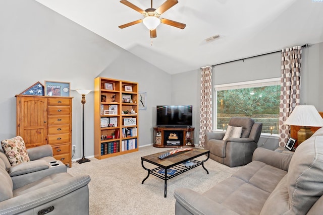 carpeted living room featuring ceiling fan and vaulted ceiling