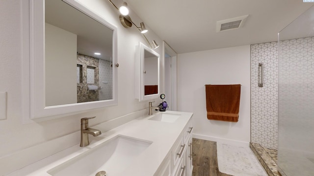 bathroom with vanity, hardwood / wood-style flooring, and walk in shower