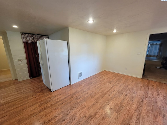 spare room featuring light wood-type flooring