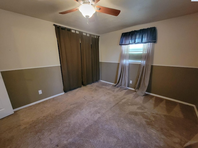 spare room featuring carpet floors and ceiling fan