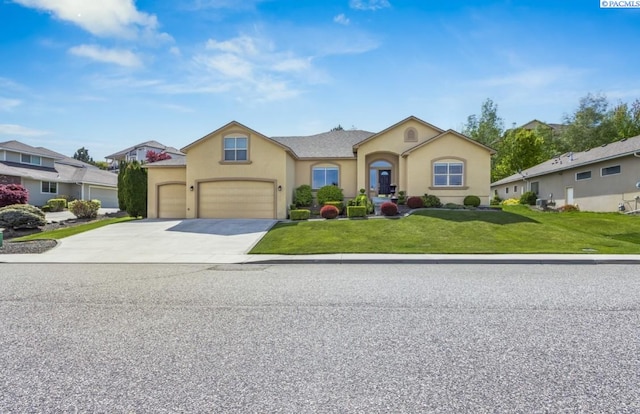 view of front of house with concrete driveway, a front lawn, and stucco siding