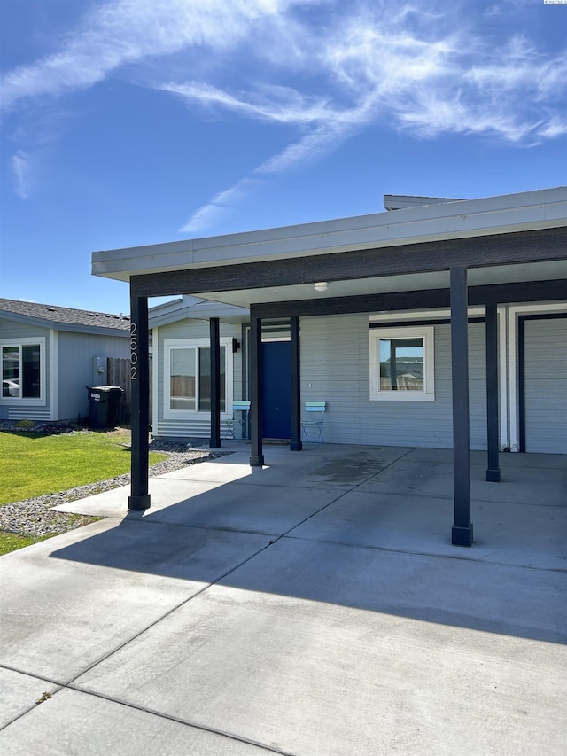 2502 Blaine St, Pasco, WA 99301 - view of front of home with an attached carport, a front yard, and driveway