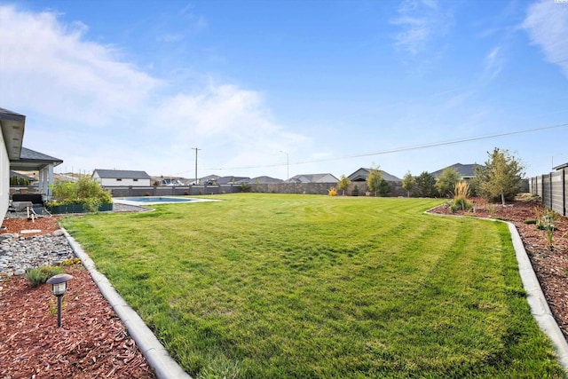 view of yard featuring a residential view and fence