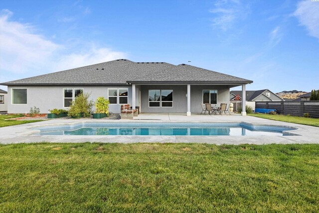 back of house with a patio area, fence, stucco siding, and a yard