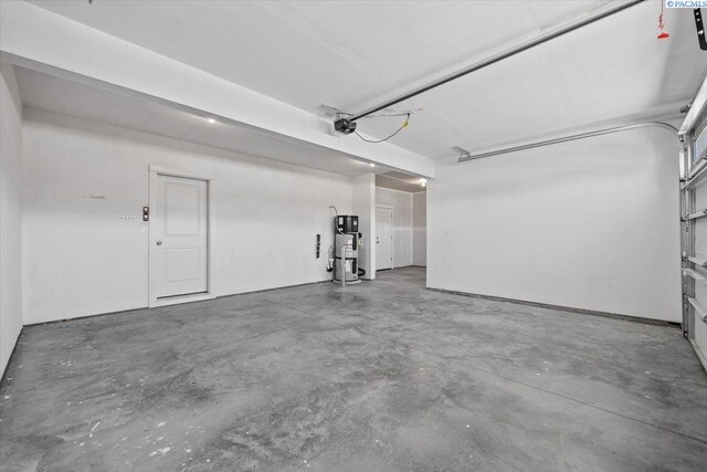 200 Ladera St, Prosser, WA 99350 - garage with water heater and a garage door opener