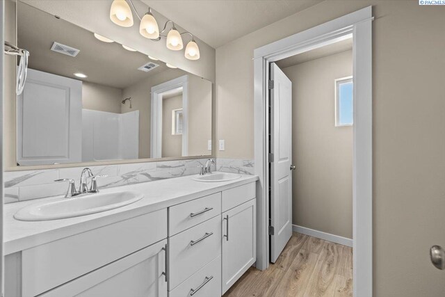200 Ladera St, Prosser, WA 99350 - full bath featuring wood finished floors, double vanity, a shower, and baseboards